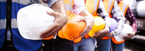 Crew on construction workers with hard hats on a job site